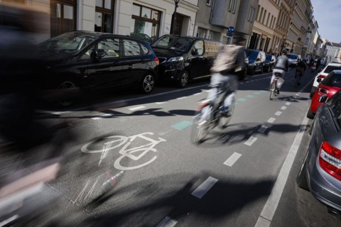 Symbolic photo on the subject of bicycle lanes in the city. Cyclists ride on the bicycle street in Linienstrasse in Berlin Mitte. Berlin