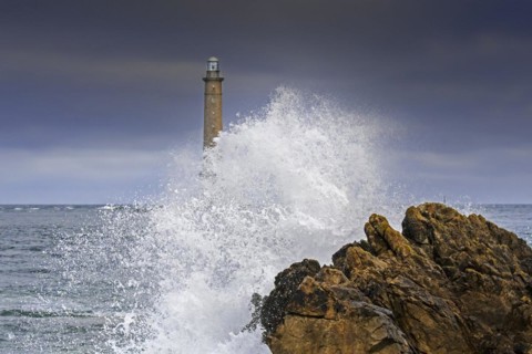 Wave crashing on rock and Phare de La Hague