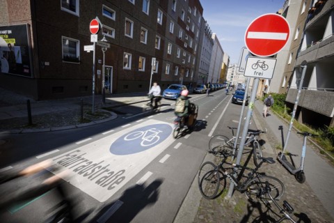 Symbolic photo on the subject of bicycle lanes in the city. Cyclists ride on the bicycle street in Linienstrasse in Berlin Mitte. Berlin