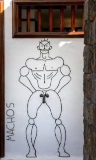Artfully designed sign at the men's toilet
