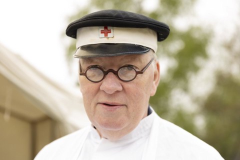 Volunteer of the Red Cross presents a historical outfit