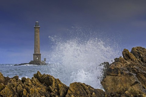 Wave crashing on rock and Phare de La Hague
