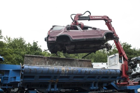 Crushed cars in scrap yard UK