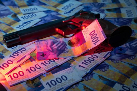 Elegant Semiautomatic 9mm Handgun with Swiss Helvetia Symbol Leaning on Swiss Franc 1000 Banknote in Switzerland