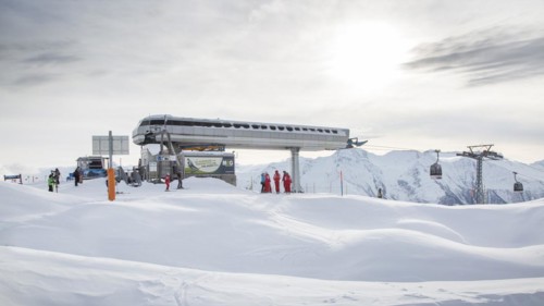 Moosfluh gondola station and Swiss ski instructors gathering on top of ski slope near the Aletsch Glacier in winter