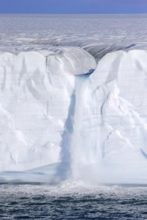 Waterfall at edge of the Brasvellbreen glacier from the ice cap Austfonna debouching into the Barents Sea