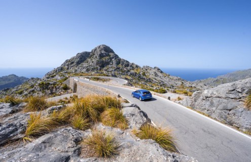 Car at the mountain pass with switchbacks to Sa Colobra