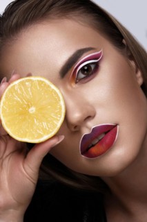 Beautiful caucasian woman with creative makeup and purple lips. Beauty face. Art makeup