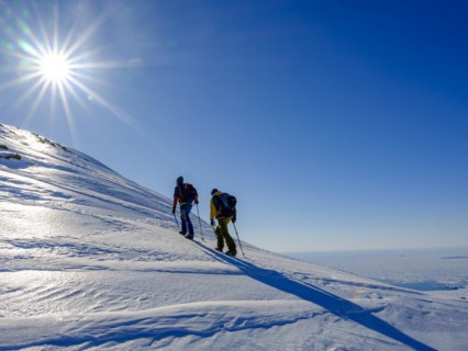 Climbers climb over ice on the local mountain
