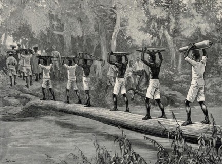Nigerian porters carrying gun parts across a river to fight slavery