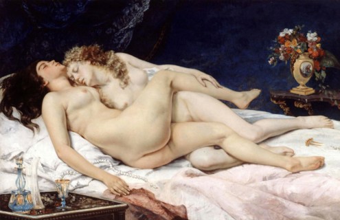 Two naked woman in a bed