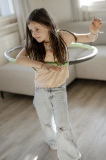 Girl gymnastics with hula hoop