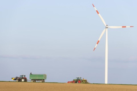 Tractor with trailer sowing grain in a field
