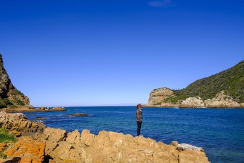 Man standing on rocks in front of Knysna Heads