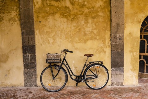 A bicycle leaning against the wall inside Saint Francis cloister in Sorrento