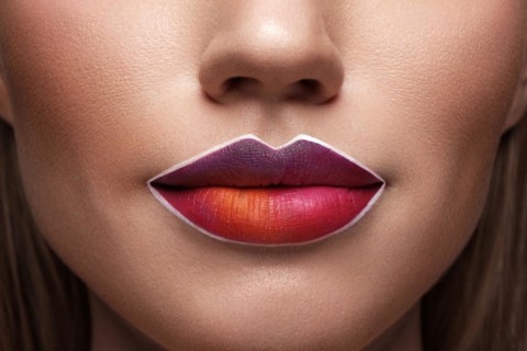 Beautiful caucasian woman with creative makeup and purple lips. Beauty face. Art makeup