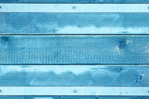 Wooden background with blue colored planks