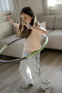 Girl gymnastics with hula hoop