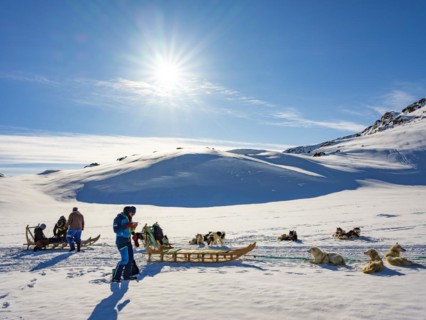 Inuit with their dog sled teams and ski tourers