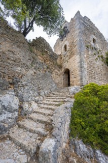 Stone steps and tower of the castle ruins Castell Alaro