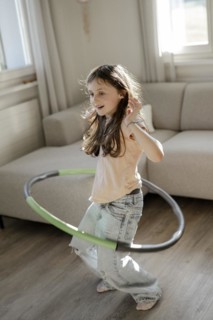 Girl gymnastics with hula hoop