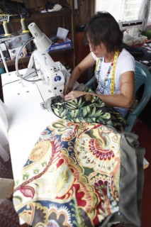 Costa Rican woman sews a bag from recycled fabric