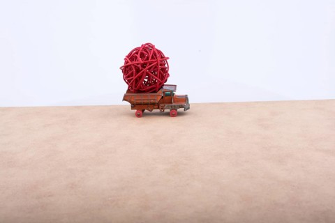 Toy car truck isolated on white and wooden background