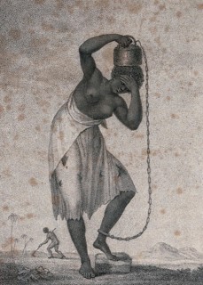 A slave woman carrying a weight on her head. A Woman Carrying a Weight on Her Head Attached to Her Ankle by a Chain