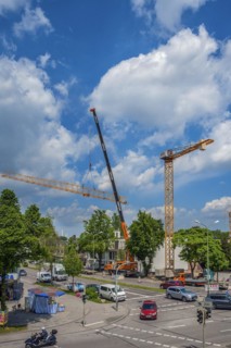 A construction crane is erected with a truck-mounted crane