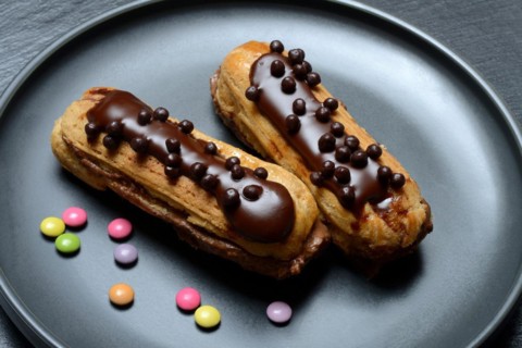 Two chocolate eclairs on a plate