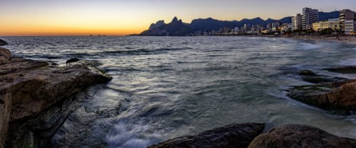 Panoramic image of the sunset at Ipanema beach in Rio de Janeiro with the sea