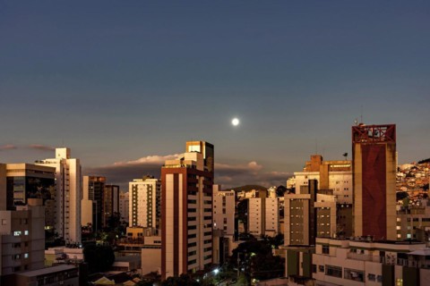 City of Belo Horizonte in the southeastern region of Brazil seen at dusk with the full moon over the buildings