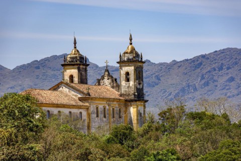 View from behind an old colonial-style church in the historic city of Ouro Preto in Minas Gerais and its mountains