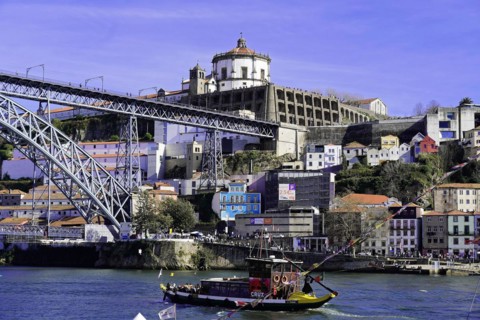 View of the Dom Luis I bridge over Douro River and terracota rooftops