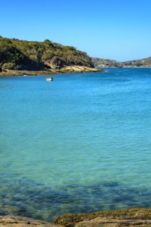 Small wooden fishing boat on the turquoise waters of Buzios on the north coast of Rio de Janeiro