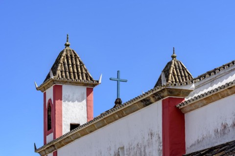 Old and historic baroque church towers seen from behind in the small tourist town of Lavras Novoas