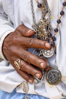 Detail of hands holding religious symbols during a popular festival in Brazil in honor of Saint George