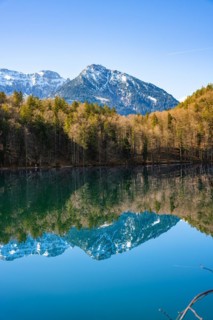 View over the green lake with mountain in the background