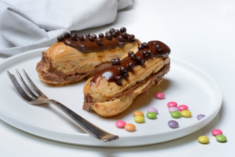 Two chocolate eclairs on a plate