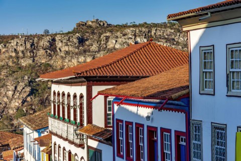 Detail of colonial style streets and houses in the old and historic city of Diamantina in Minas Gerais with the mountains in the background during the late afternoon