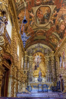 Interior and altar of a brazilian historic ancient church from the 18th century in baroque architecture with details of the walls in gold leaf in the city of Rio de Janeiro