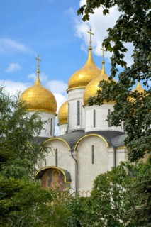 Orthodox Christian church with golden domes inside the Kremlin gardens in Moscow