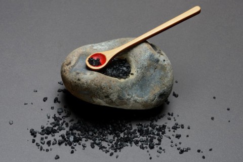 Black Hawaiian salt on spoons and in hollowed stone