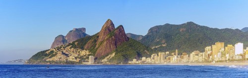 Panoramic image of early morning on Ipanema beach in Rio de Janeiro still empty with its buildings and the surrounding mountains