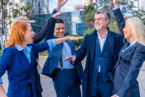Senior Executives with Positive Attitude High-Five to Mark Achievement and Progress