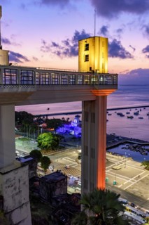 Facade of the famous Lacerda elevator illuminated at night of the city of Salvador in Bahia with the sea in background