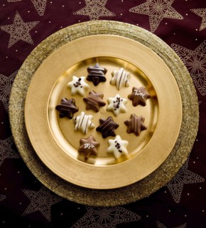 Chocolates as Christmas stars on a golden plate