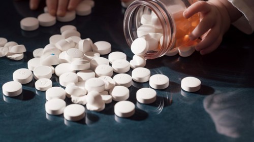 A young toddler has found some prescription pills at home