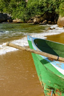 Rowing fishing boat on the shore of the unspoiled beach of Ilha Grande