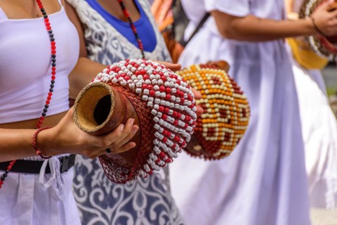 Woman playing a type of rattle called xereque of African origin used in the streets of Brazil during samba performances at traditional carnival festivities